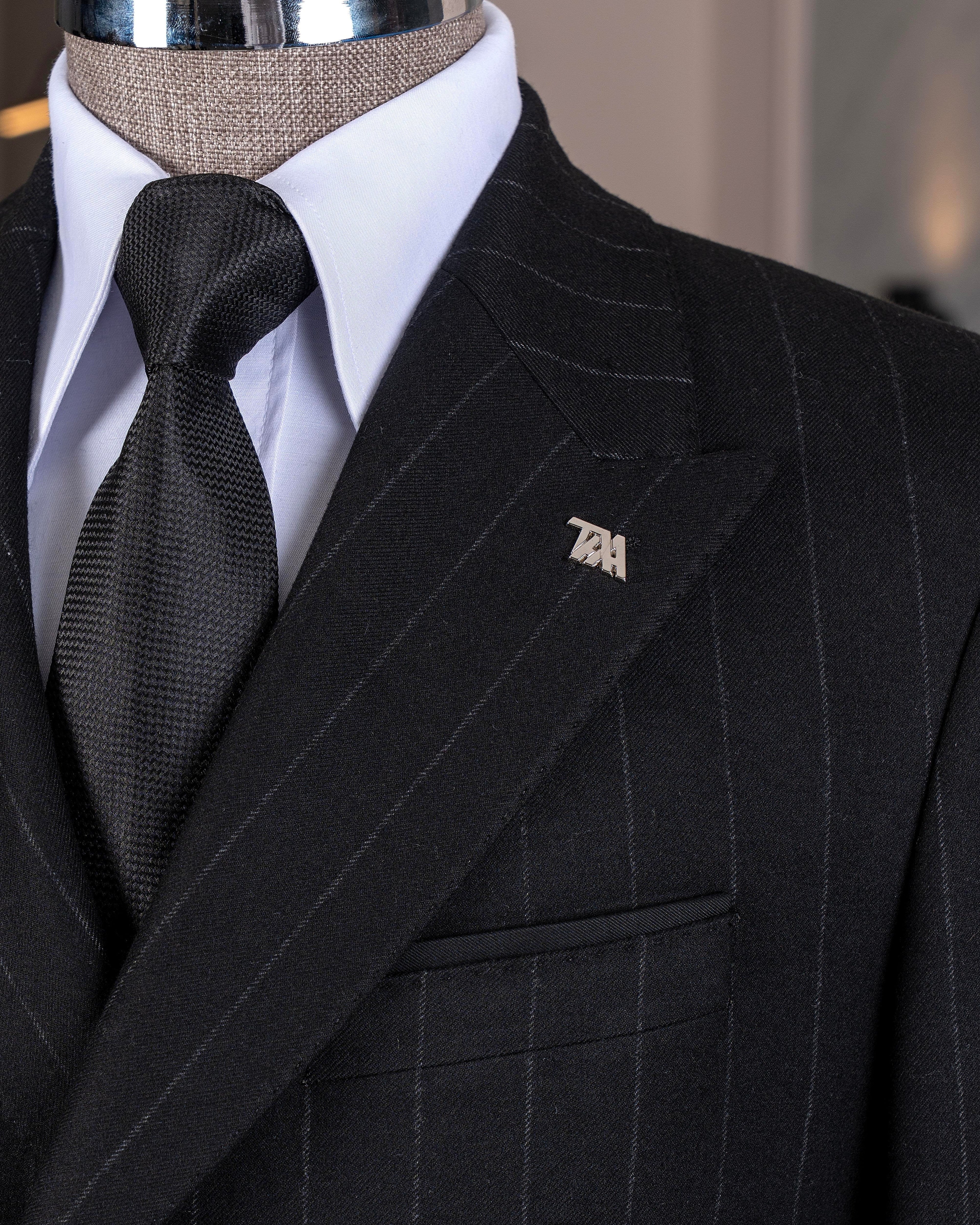 Close-up of a black stripe suit with a wooden hand wearing a white shirt cuff, featuring a 'French Cuff' label.